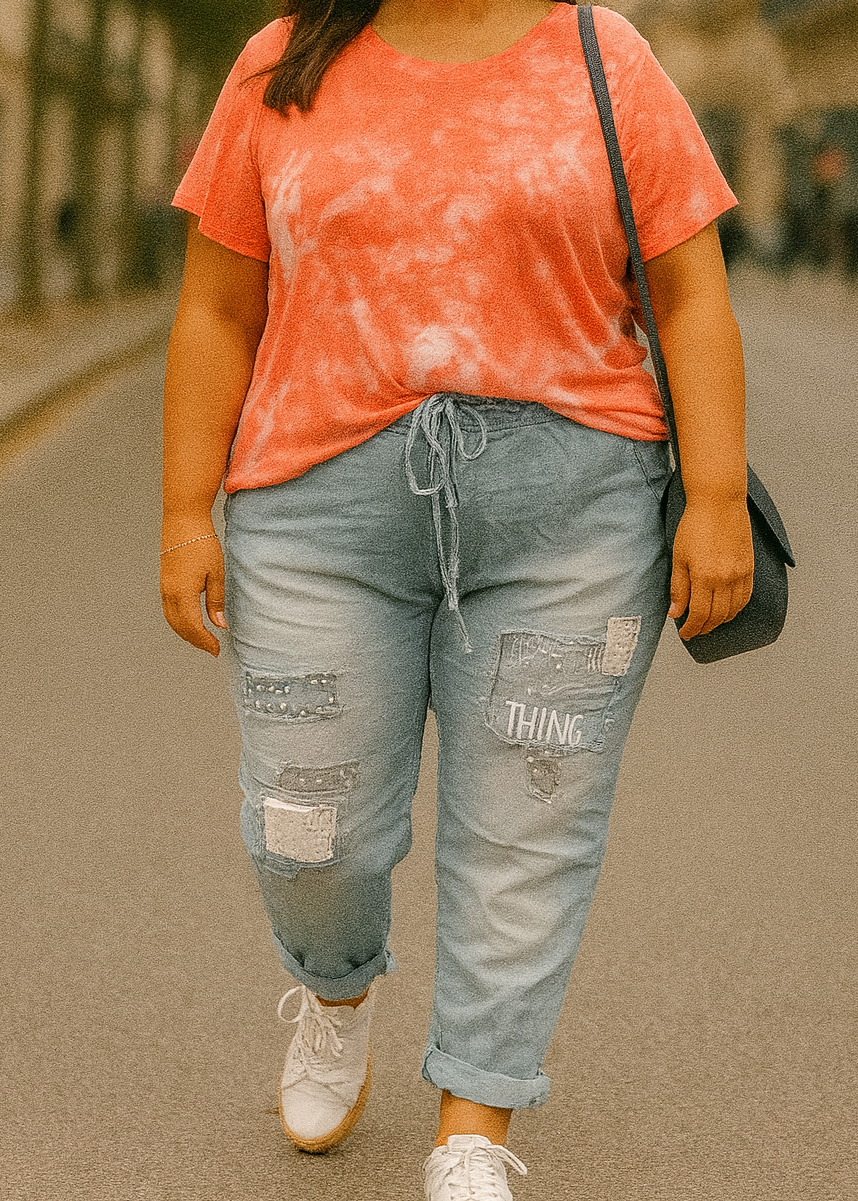 Pantalon jogging bleu clair pour femme, coupe décontractée avec taille élastique et lien de serrage, décoré de patchs brodés, clous et sequins argentés. Style streetwear tendance et confortable.