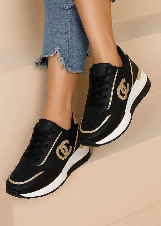 Baskets femme noires compensées avec logo entrelacé taupe, finitions dorées au talon et surpiqûres, semelle blanche compensée, style chic et urbain – Timalya.