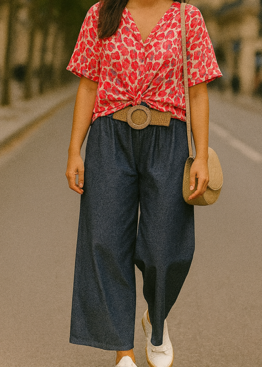 Pantalon large en denim léger foncé, coupe fluide style palazzo, ceinture élastique tressée beige avec boucle ronde dorée. Look décontracté chic, parfait pour le printemps et l’été.